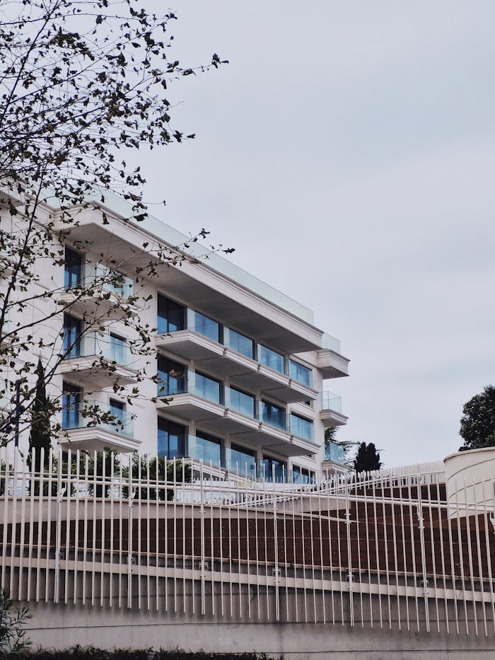 Contemporary apartment building with glass balconies and minimalistic design.