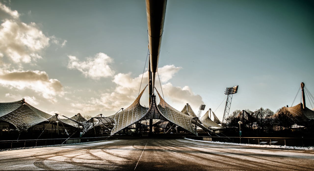 A stunning view of Munich's Olympic Park architecture under a bright sky.